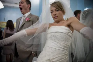 Wedding guest yawning behind the bride, an example of a poor candid photo