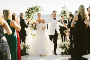 Bride and groom walking down the aisle at a formal outdoor wedding ceremony