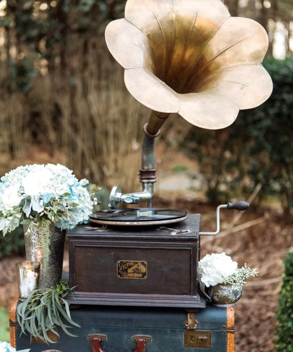 Vintage gramophone and suitcase decorated with white hydrangeas for a wedding theme