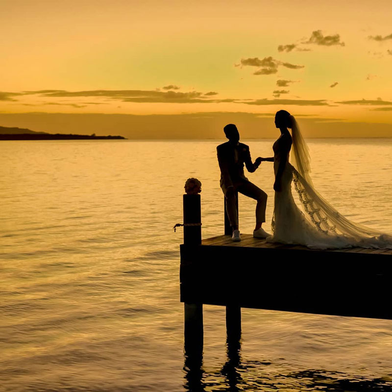 Weddings Roatan couple on the dock at the sunset nearest