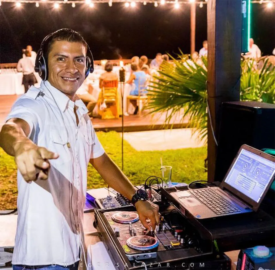 Wedding DJ at his turntables during a reception in Roatán