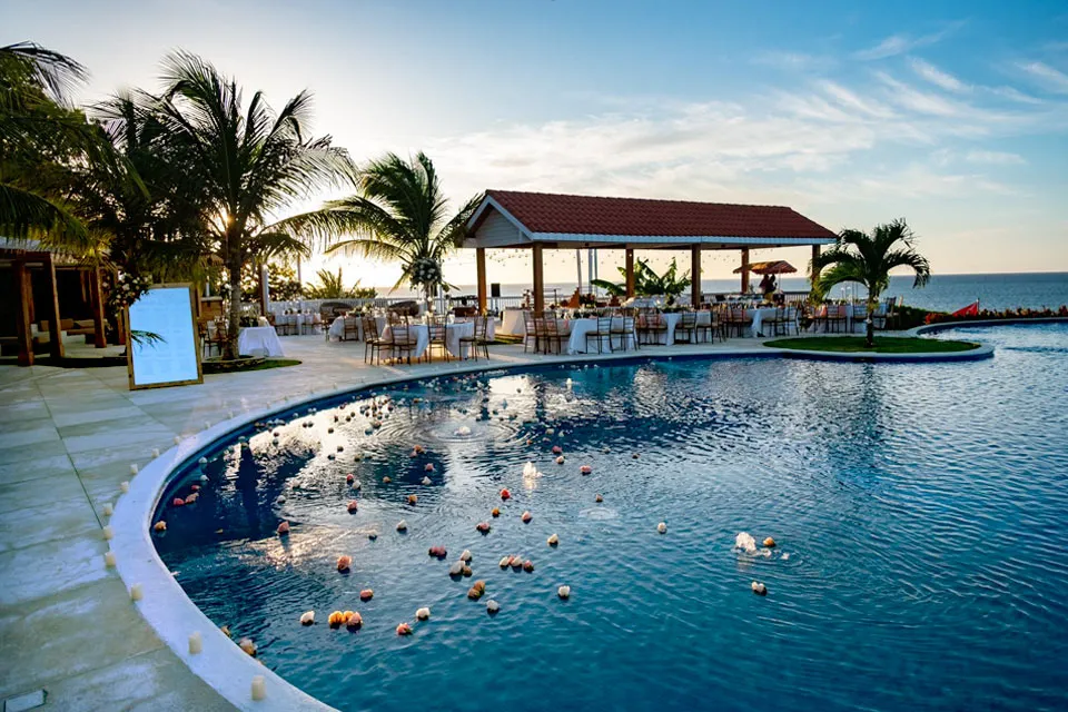 Pool decorated with floating flowers for an event at Pristine Bay