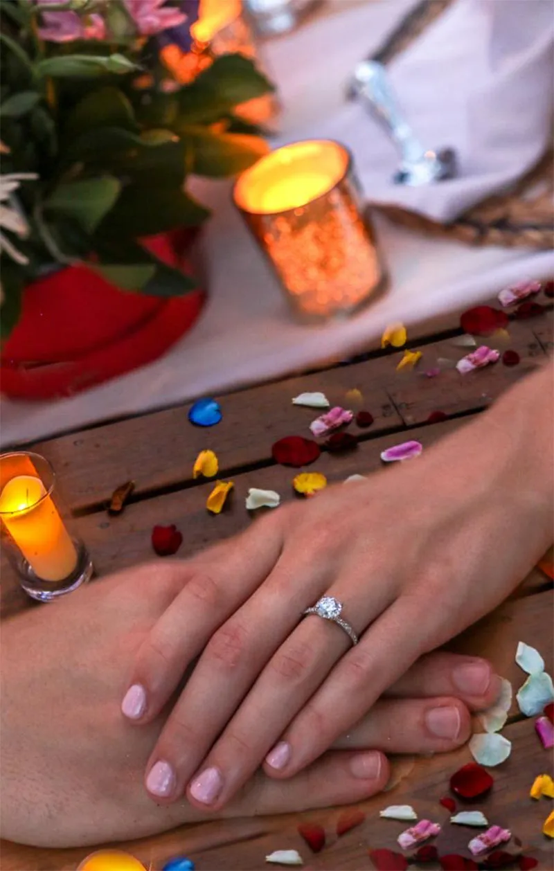 Close-up of hands showing an engagement ring
