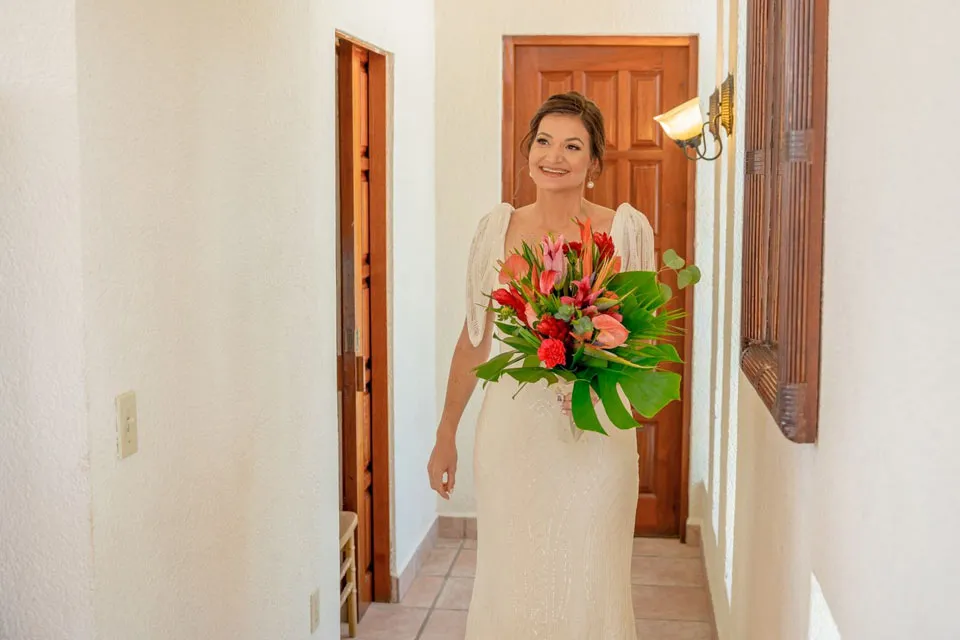 Bride holding a tropical bouquet with gingers and birds of paradise