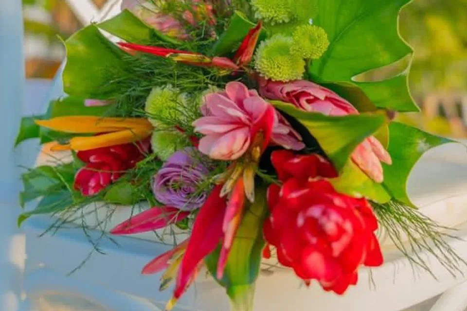 Tropical wedding bouquet with red gingers, roses and birds of paradise