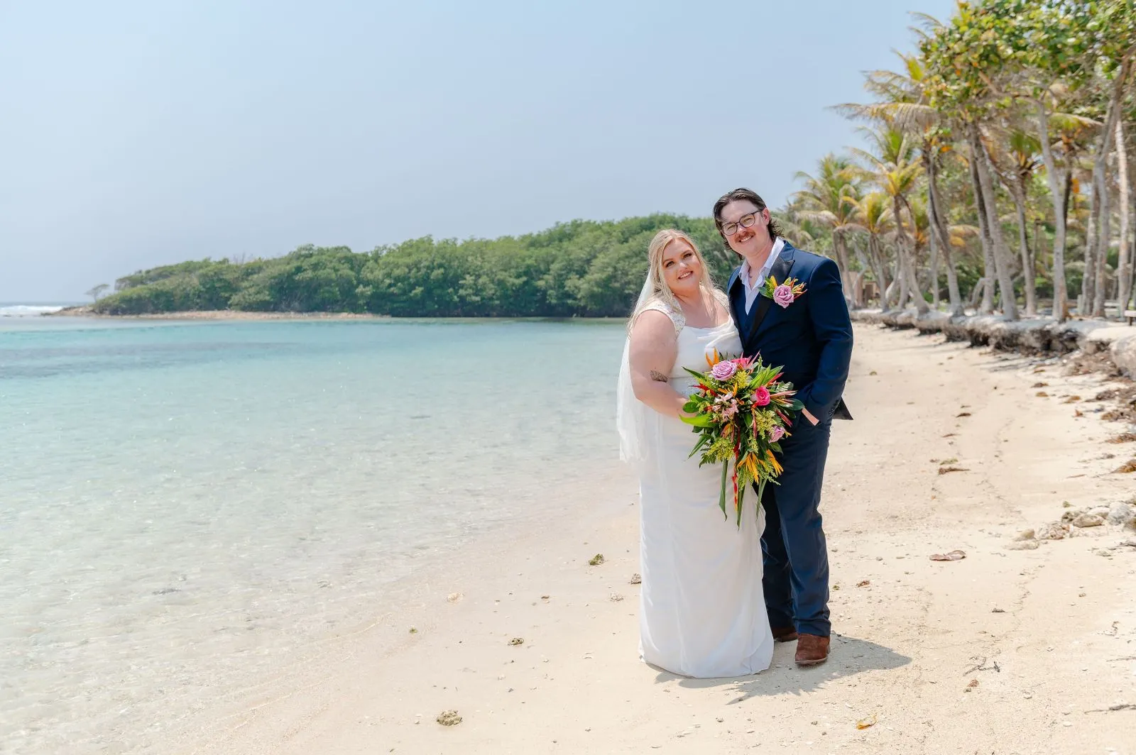 Bride and groom on a quiet beach during a cruise wedding in Roatán