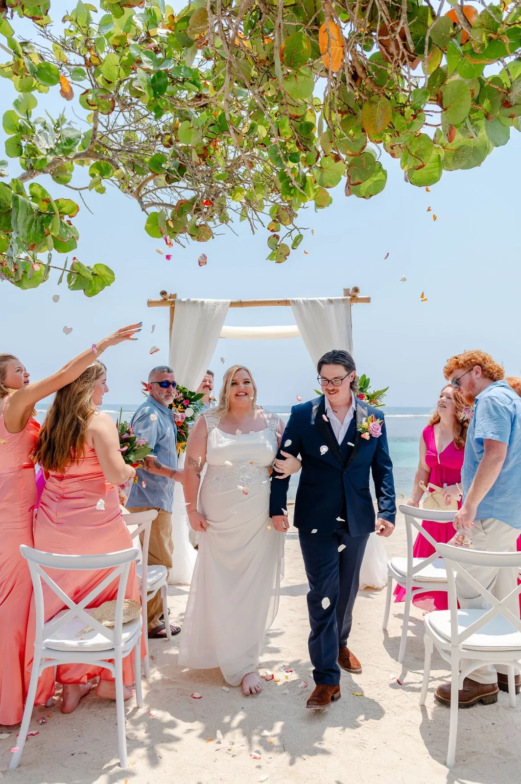 Newlyweds walking up the aisle at a beach cruise wedding in Roatán