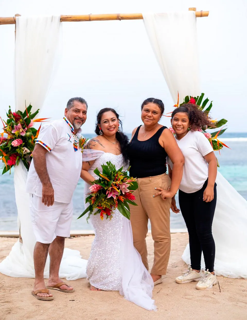 Wedding planner Cecilia Mendez with a bride and groom on the beach in Roatán