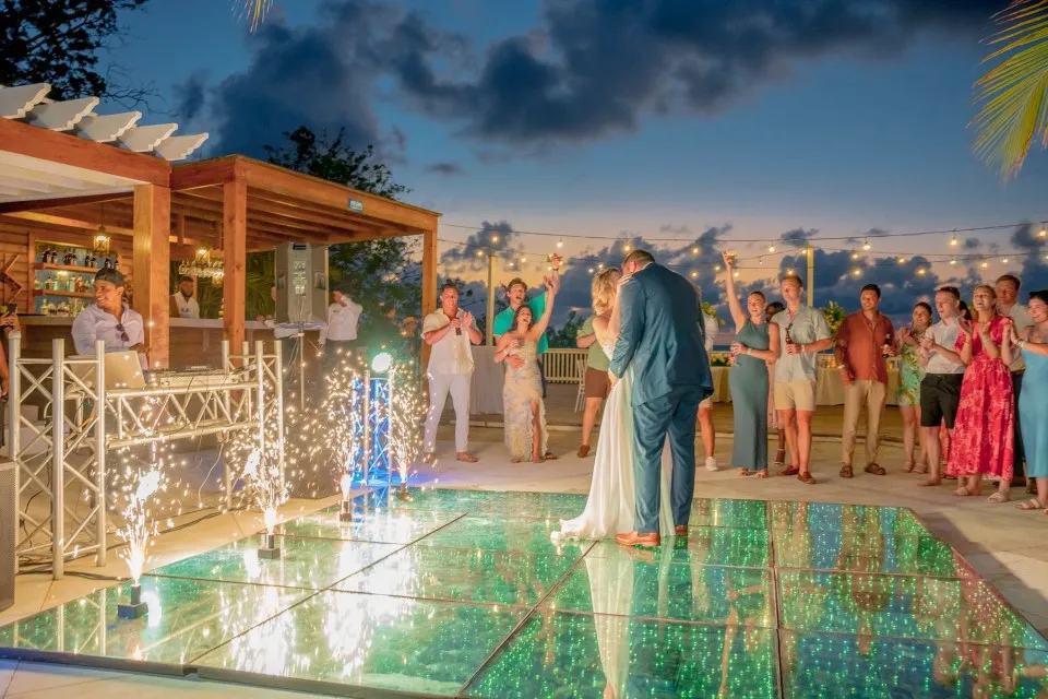 Ben and Natalia dancing on a lit dance floor at Pristine Bay