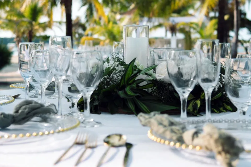 Wedding table with glassware and greenery centerpiece