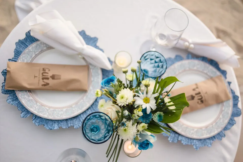 Proposal dinner table with blue plates and white flowers