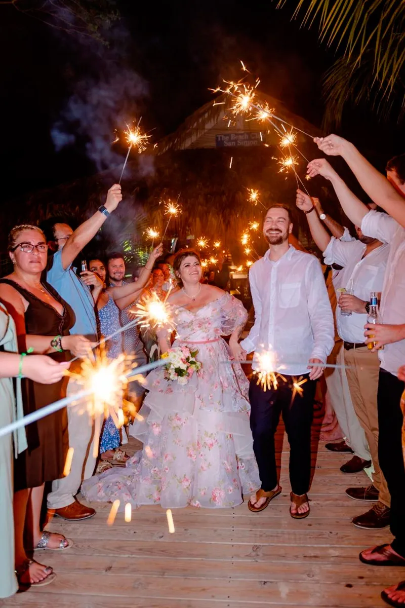 Guests holding sparklers for the bride and groom's exit