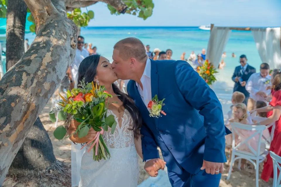 Weddings Roatan Weddings That Fit Your Shore Time and Your Dreams (1) Groom kissing the bride after a cruise wedding ceremony in Roatán